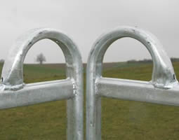 Two galvanized feed fence arch bars details